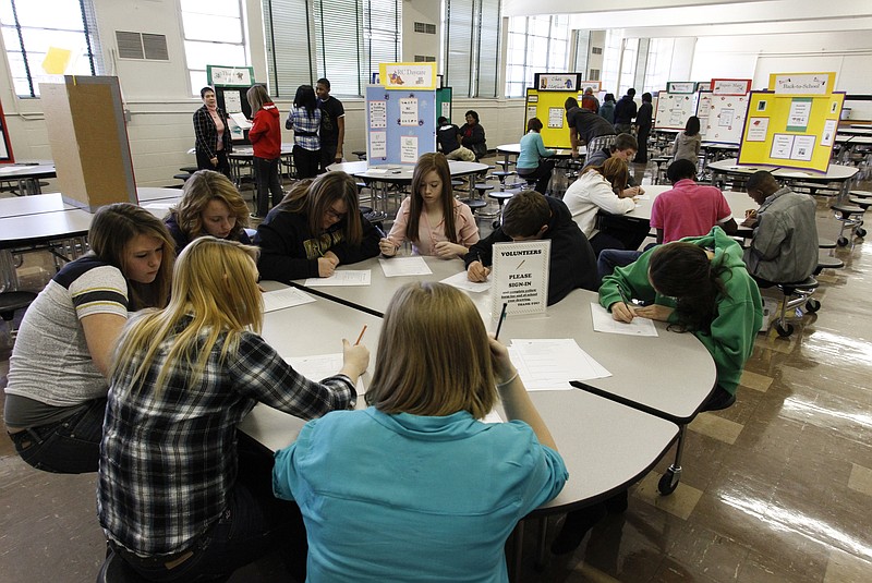 In this Jan. 22, 2013, staff file photo, students at Lookout Valley High School fill out a survey during "Reality Check," a program sponsored by the Chattanooga Chamber of Commerce that teaches ninth-grade students how to budget their money.