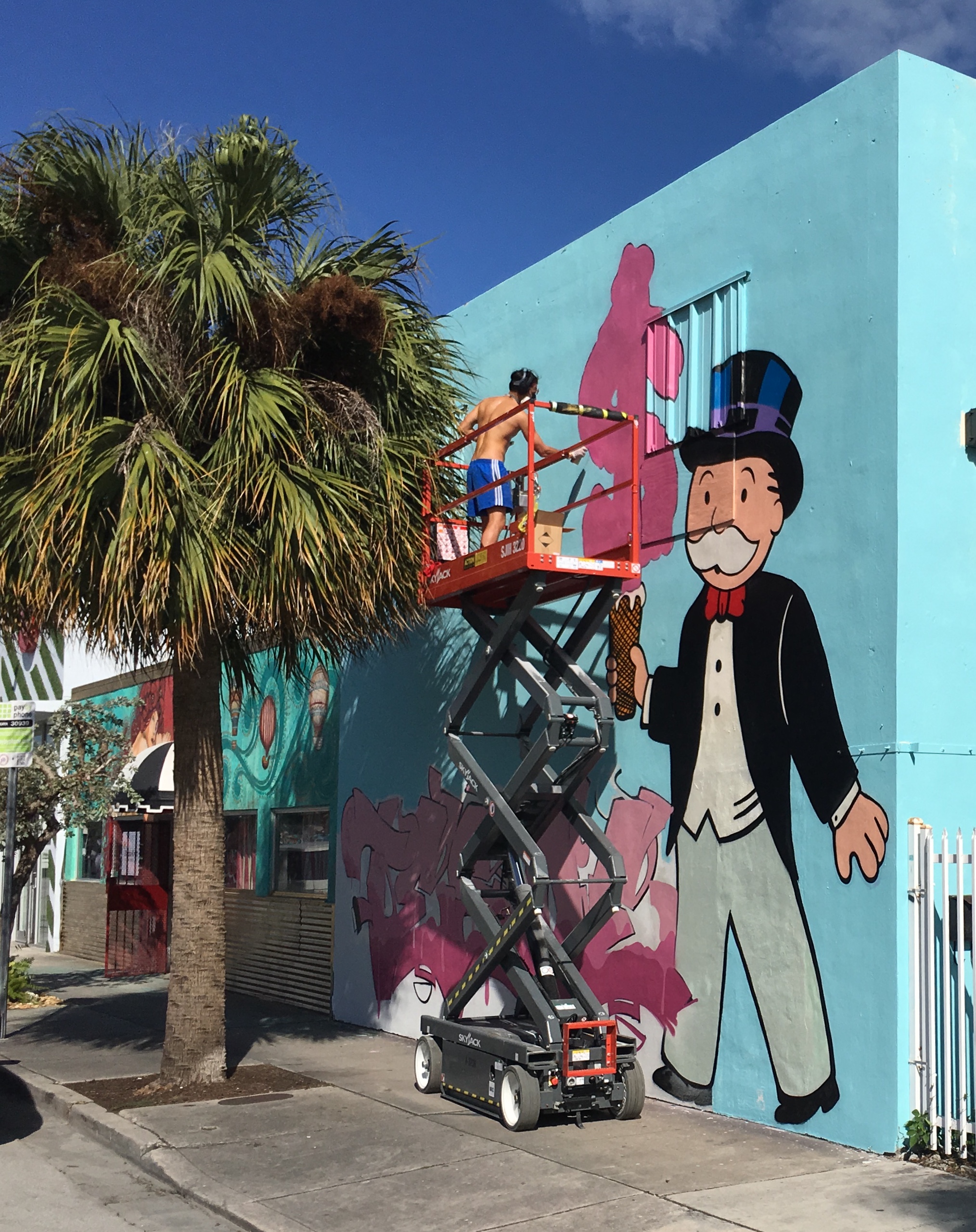 A painter adds finishing touches to a new mural in the Wynwood Art District, the epicenter of Miami's exploding art scene. (Photo by Martin W.G. King)