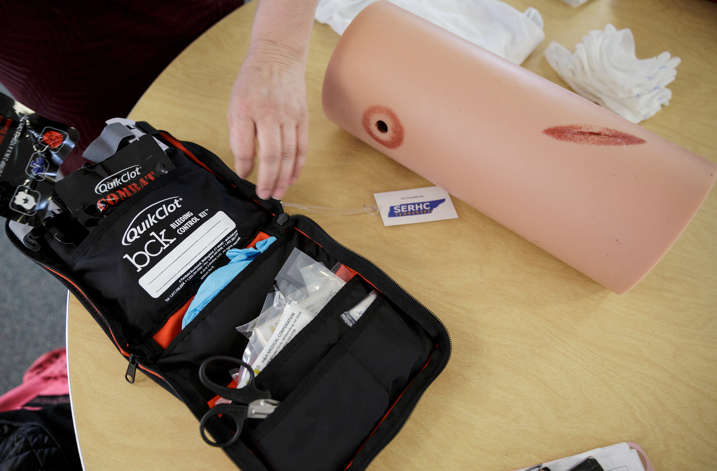 Nurse Regena Young rolls out a first aid kit that will be given to Brainerd High School next to a wound-packing practice device during a "Stop the Bleed" class at the school on Wednesday, April 11, 2018, in Chattanooga, Tenn. Erlanger Hospital provided first aid training focused on slowing blood loss in trauma victims for the health occupations classes and interested faculty and students at Brainerd.