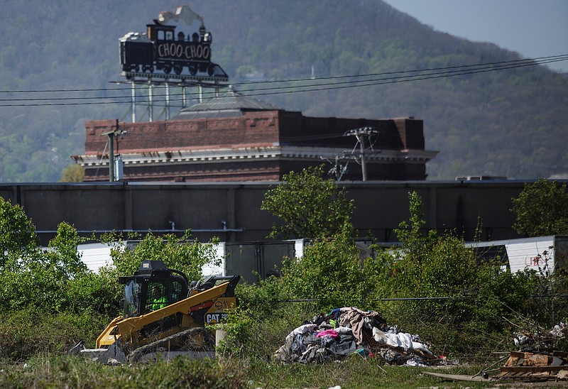 A bulldozer makes piles of trash and tents on the former site of a homeless encampment on city-owned property behind the municipal wellness center on East 11th Street on Thursday, April 12, 2018, in Chattanooga, Tenn. The camp's residents were removed from the site because the property is a toxic brownfield. Out of 130 residents counted in the camp, 80 have applied for housing through Chattanooga Housing Authority and 8 have been approved, according to Twitter posts by Mayor Andy Berke's deputy chief of staff Kerry Hayes.