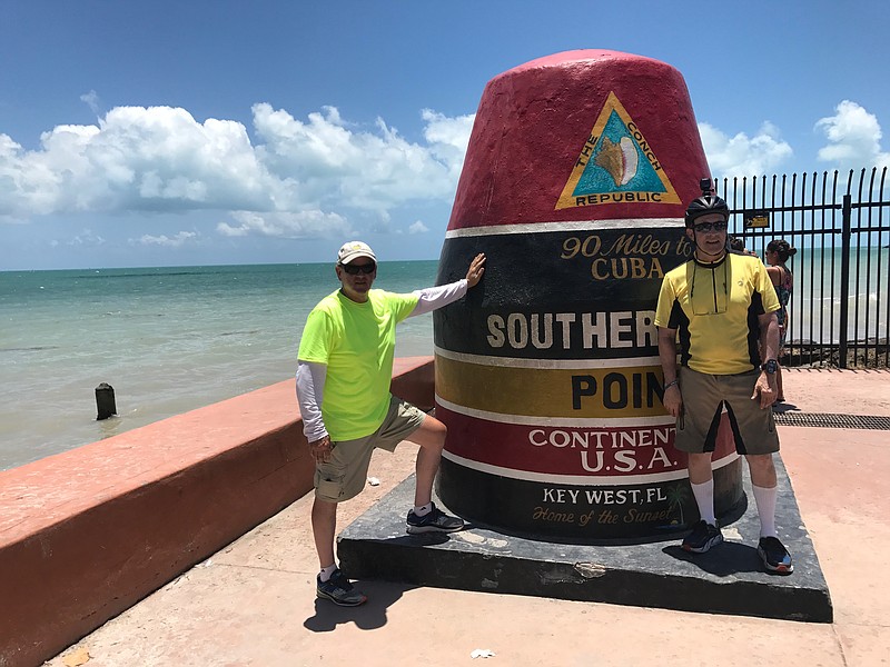 Jack Goodlet, left, and cousin, Cliff Goodlet, stand at the southernmost point of the continental U.S. in Key West, Fla. The two North Georgia residents have been cycling across the region.