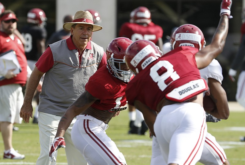 Alabama football coach Nick Saban watches defensive back Saivion Smith (8) close in on receiver DeVonta Smith during a practice this spring. DeVonta Smith also has worked some in the secondary due to the lack of depth.
