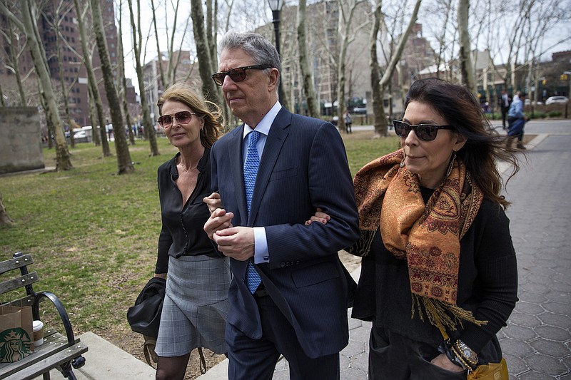 
              Actress Catherine Oxenberg, left, arrives at federal court with Stanley Zareff and Toni Natalie, who is Keith Raniere's ex-girlfriend, for the arraignment of NXIVM leader Raniere on Friday, April 13, 2018, in New York. Oxenberg's daughter India has been named as a co-conspirator in a criminal complaint against Raniere. (AP Photo/Kevin Hagen)
            