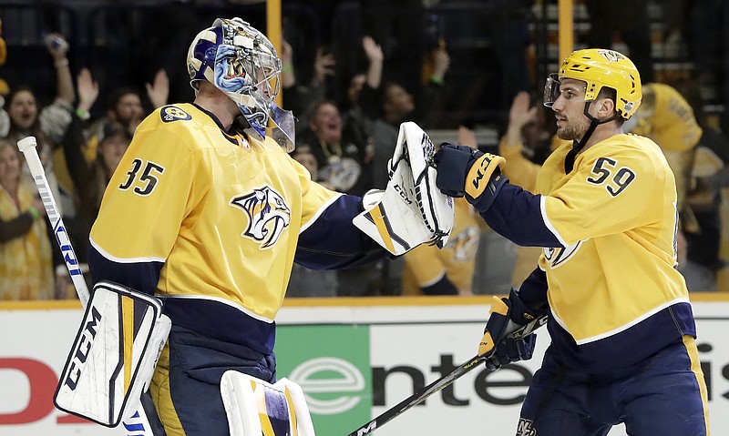 Nashville Predators goalie Pekka Rinne (35), of Finland, and defenseman Roman Josi (59), of Switzerland, celebrate after beating the Colorado Avalanche in Game 2 of an NHL hockey first-round playoff series Saturday, April 14, 2018, in Nashville, Tenn. The Predators won 5-4 to take a 2-0 lead in the series. (AP Photo/Mark Humphrey)