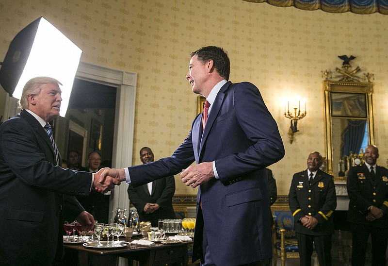 New York Times file photo — President Donald Trump shakes hands with James Comey, the FBI director, at the White House in Washington, D.C., in January 2017.