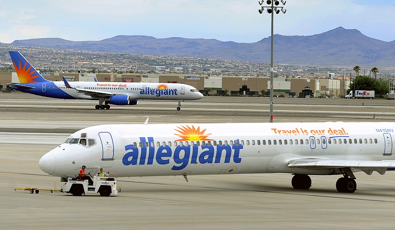 File - In this May 9, 2013, file photo, two Allegiant Air jets taxi at McCarran International Airport in Las Vegas. Shares of Allegiant Air’s parent company are tumbling in Monday, April 16, 2018, premarket trading following a “60 Minutes” investigation that expressed serious safety concerns about the airline. (AP Photo/David Becker, File)