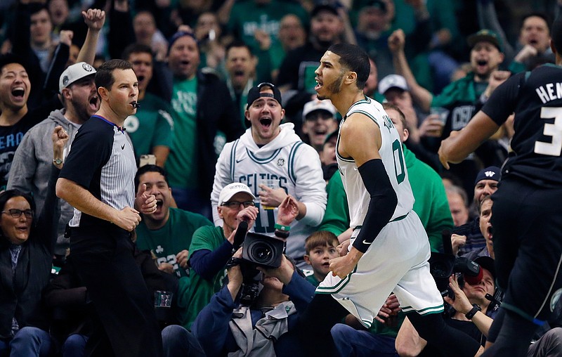 Boston Celtics' Jayson Tatum reacts after scoring during the first quarter of Game 1 of an NBA basketball first-round playoff series against the Milwaukee Bucks, in Boston, Sunday, April 15, 2018. (AP Photo/Michael Dwyer)