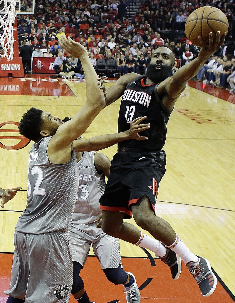 Houston Rockets' James Harden shoots over Minnesota Timberwolves' Karl-Anthony Towns during the first half in Game 1 of a first-round NBA basketball playoff series Sunday, April 15, 2018, in Houston. (AP Photo/David J. Phillip)