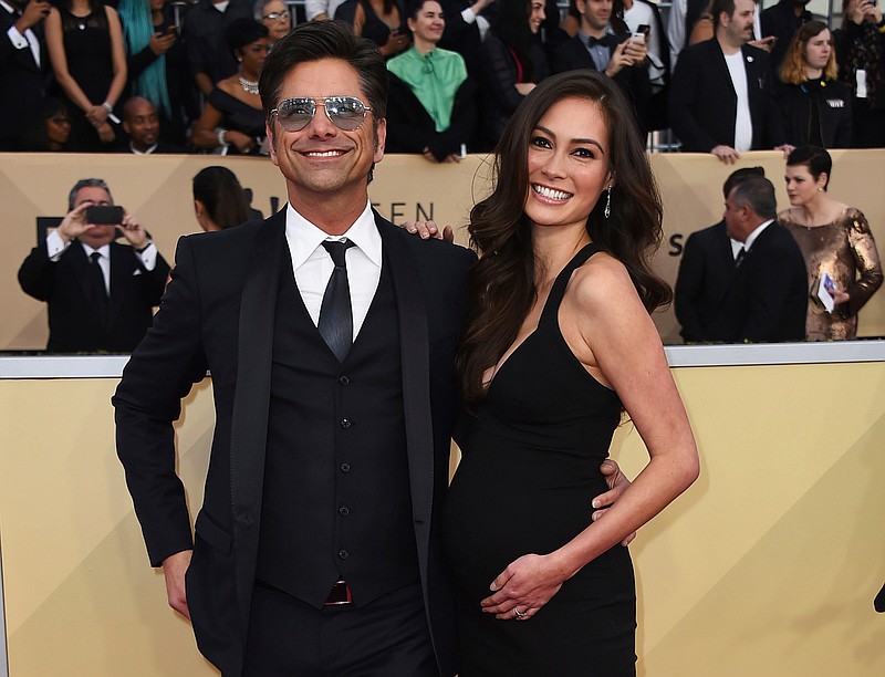 
              FILE - In this Jan. 21, 2018, file photo, John Stamos, left, and Caitlin McHugh arrive at the 24th annual Screen Actors Guild Awards at the Shrine Auditorium & Expo Hall in Los Angeles. Stamos announced on Instagram the birth of his son, Billy Stamos. (Photo by Jordan Strauss/Invision/AP, File)
            