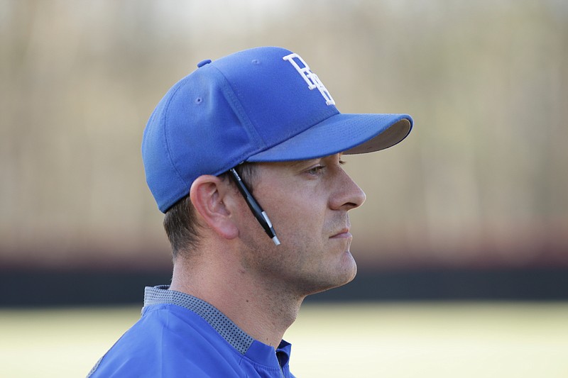 Jason Henderson stands in the coach's box beside third base during Red Bank's high school baseball game at Signal Mountain on April 17, 2018. Henderson was head coach of the Lions the past three seasons but is returning to lead the program at Lookout Valley, his alma mater and the place he began his coaching career as an assistant.