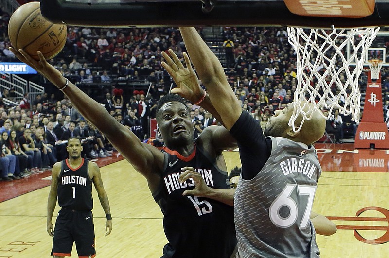 Houston Rockets' Clint Capela shoots around Minnesota Timberwolves' Taj Gibson during the first half in Game 1 of a first-round NBA basketball playoff series Sunday, April 15, 2018, in Houston. (AP Photo/David J. Phillip)