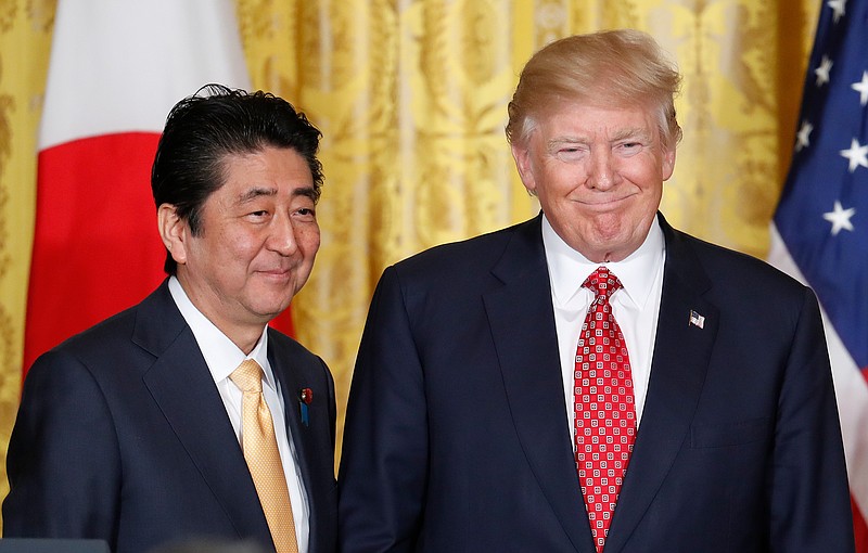 FILE - In this Feb. 10, 2017, file photo, U.S. President Donald Trump, right, and Japanese Prime Minister Shinzo Abe stand on stage together at the conclusion of their joint news conference in the East Room of the White House in Washington. Abe is heading to Trump's Mar-a-Lago resort Tuesday, April 17, 2018 for two days of talks, hoping to keep Japan's interests on the table in a possible U.S.-North Korea summit as well as stem a slide in his voter support ratings. (AP Photo/Pablo Martinez Monsivais, File)

