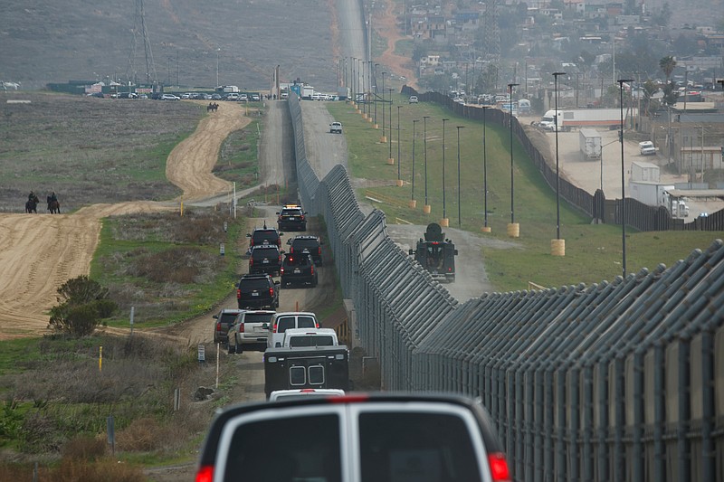 In this March 13, 2018, file photo, a motorcade carrying President Donald Trump drives along the border in San Diego. California has rejected the federal government's initial plans for National Guard troops to the border because the work is considered too closely tied to immigration enforcement. (AP Photo/Evan Vucci, File)