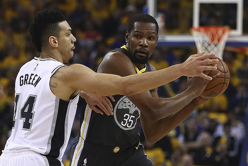 Golden State Warriors' Kevin Durant (35) is guarded by San Antonio Spurs' Danny Green (14) during the first quarter in Game 2 of a first-round NBA basketball playoff series Monday, April 16, 2018, in Oakland, Calif. (AP Photo/Ben Margot)