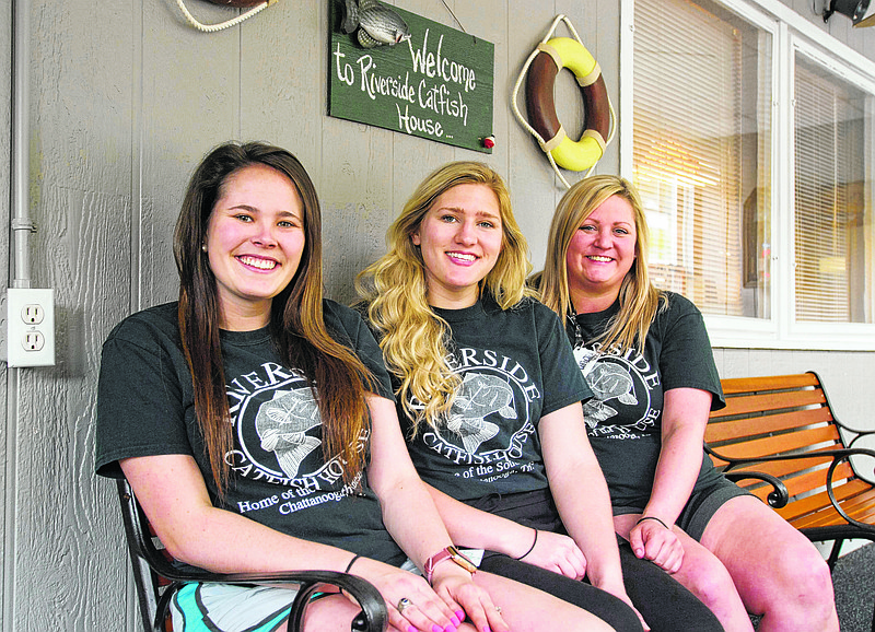 Taylor Atchley, Taylor Burrell and Brandy Huff sit on the porch at Riverside Catfish House. (Photo by Mark Gilliland)