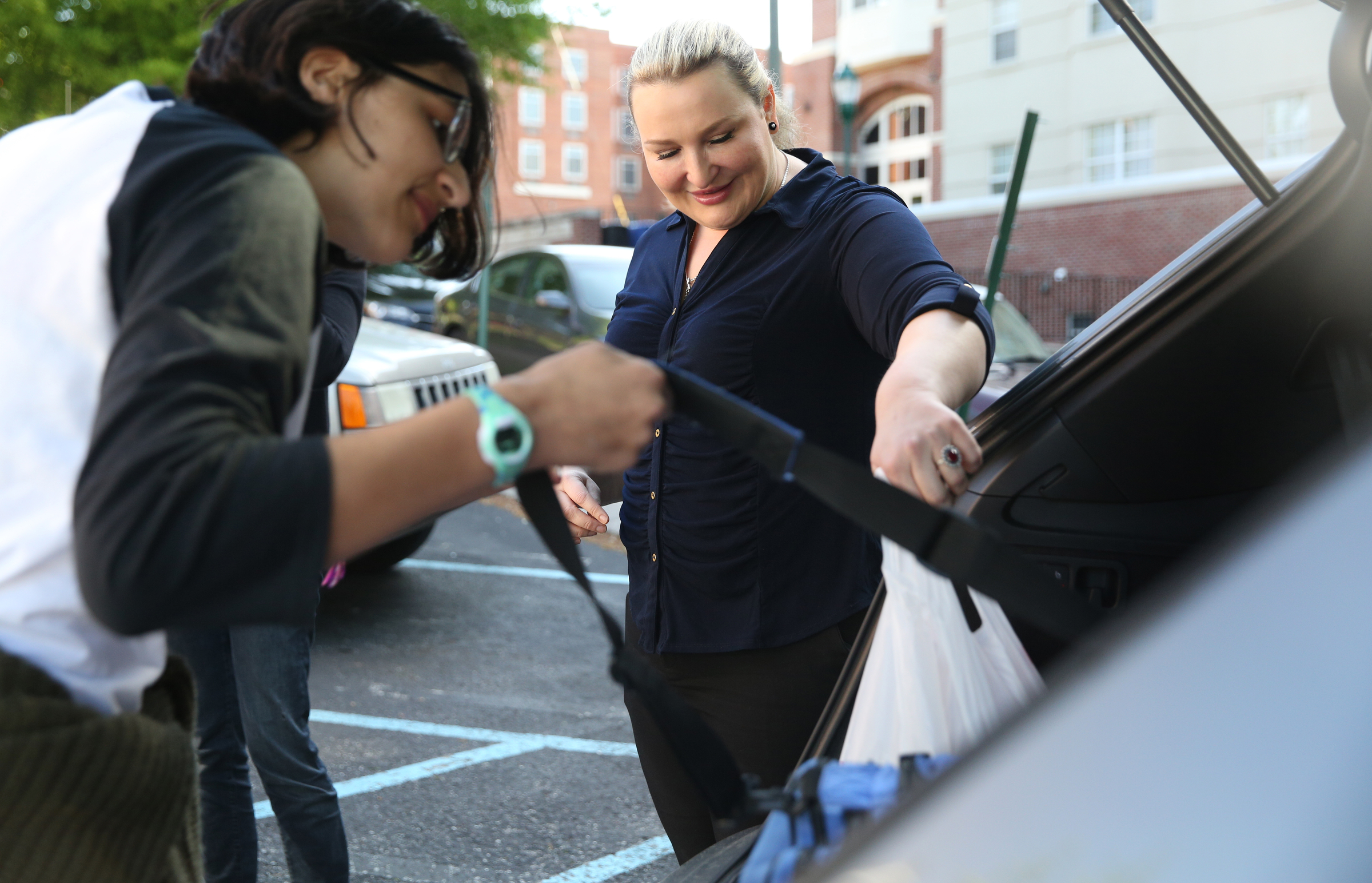 Lena Iqbal, at right, grabs a bag for her daughter Anika Iqbal, 16, as the Baylor sophomore grabs her luggage to put in a van Wednesday, April 18, 2018 at First Christian Church in Chattanooga, Tenn. The group of students from various high schools around Chattanooga are heading to Washington D.C. to meet with Senator Bob Corker and other federal lawmakers about school safety.