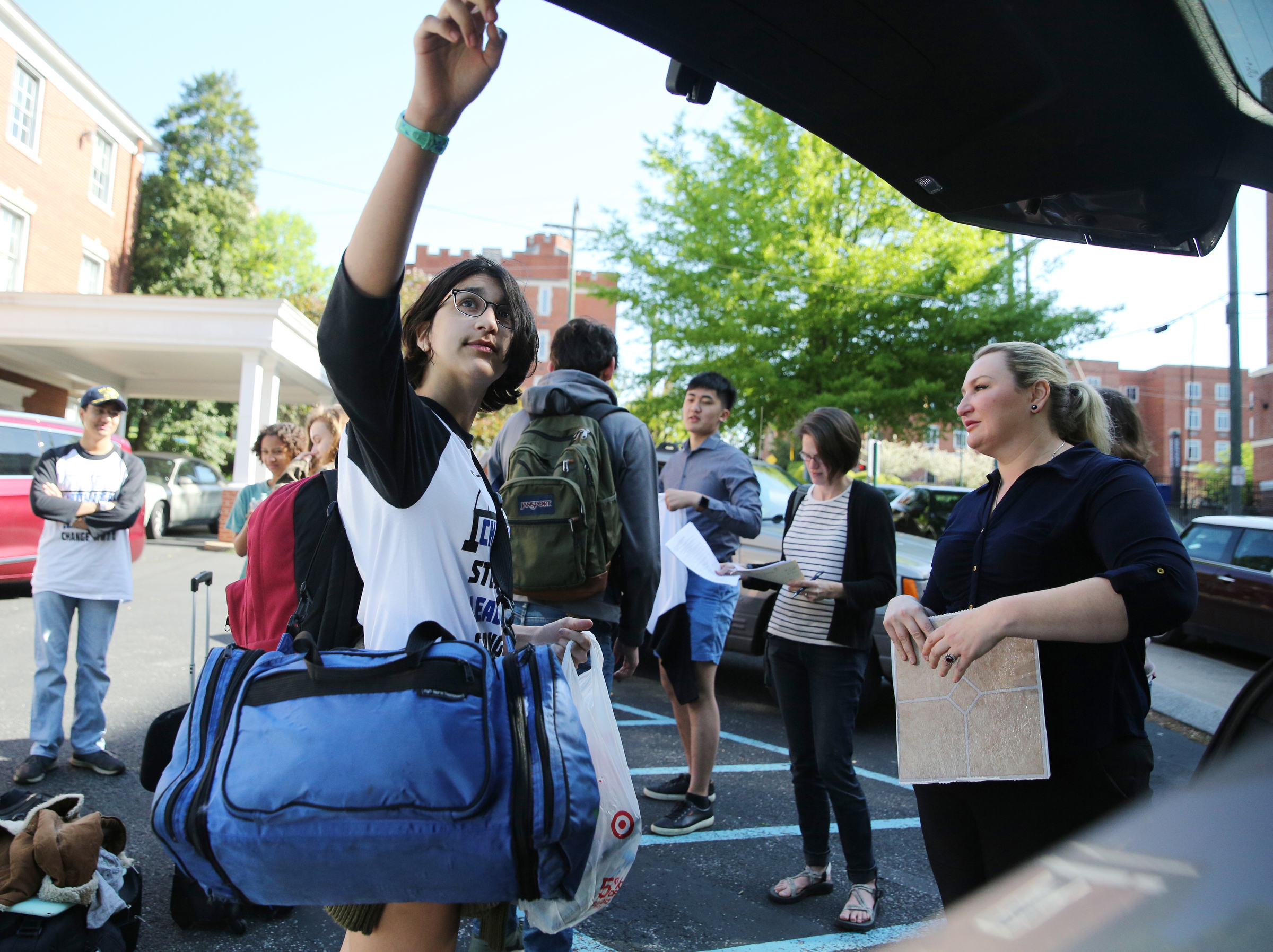 Anika Iqbal, 16, closes her mom's van after grabbing her luggage Wednesday, April 18, 2018 at First Christian Church in Chattanooga, Tenn. The Baylor School sophomore is traveling with a group of local high school students to Washington D.C. to meet with Senator Bob Corker and other federal lawmakers about school safety.