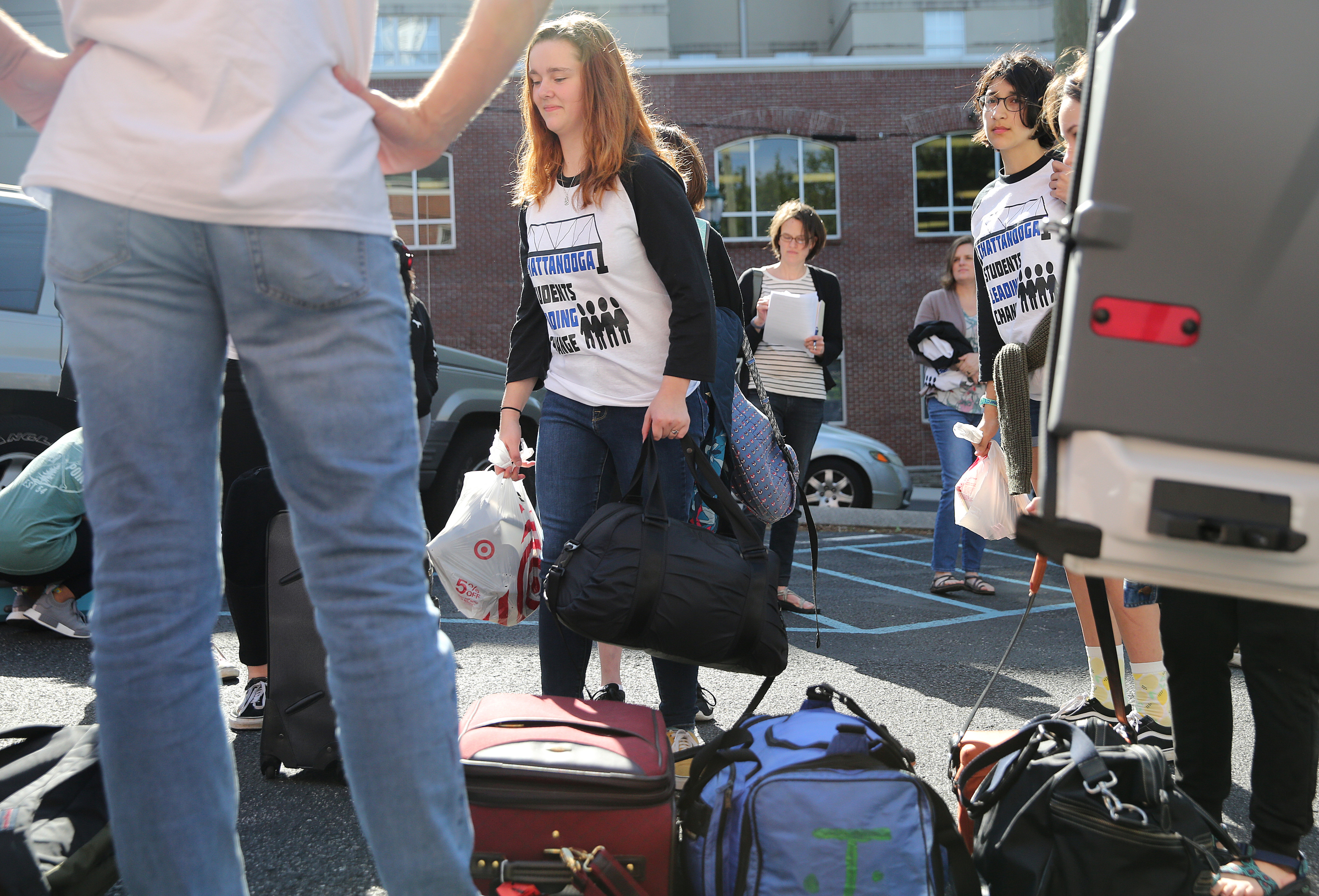 Chattanooga Center for Creative Arts freshman Julia Becker, 14, puts her bags in a pile with others to be packed into a van Wednesday, April 18, 2018 at First Christian Church in Chattanooga, Tenn. A group of students from various high schools around Chattanooga are heading to Washington D.C. to meet with Senator Bob Corker and other federal lawmakers about school safety.