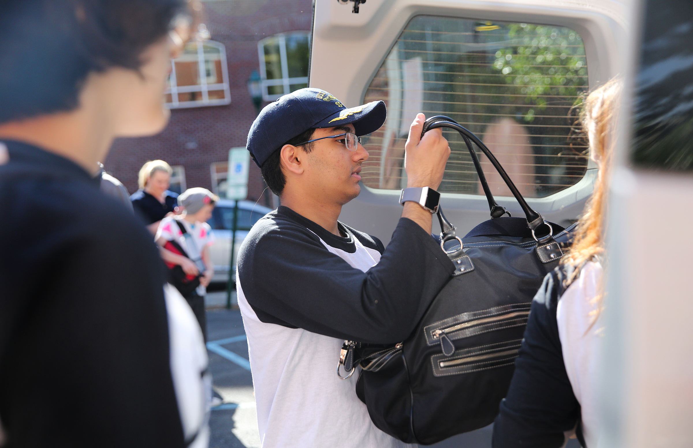 Krishna Chanamolu, 16, helps pack student bags into the back of a van Wednesday, April 18, 2018 at First Christian Church in Chattanooga, Tenn. The Baylor School sophomore is part of a group of students from various high schools around Chattanooga that is heading to Washington D.C. to meet with Senator Bob Corker and other federal lawmakers about school safety.