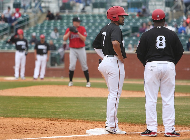 LaMonte Wade, left, talks with Lookouts manager Tommy Watkins during a recent game at AT&T Field. Wade is back in Chattanooga after playing 117 games for last season's Southern League co-champion.