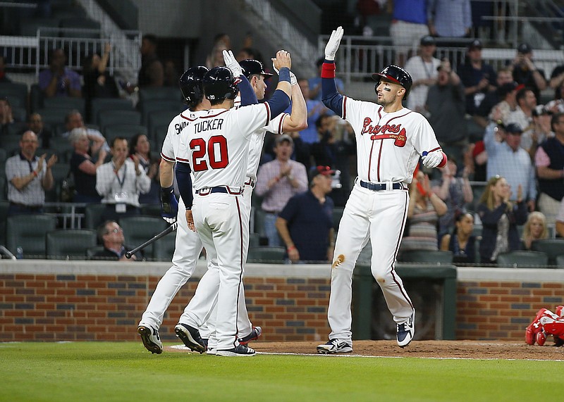 Atlanta Braves' Ryan Flaherty, right, celebrates with teammates, including Preston Tucker (20) and Danby Swanson, back left, after hitting a three-run home run in the fifth inning of a baseball game against the Philadelphia Phillies, Wednesday, April 18, 2018, in Atlanta. (AP Photo/Todd Kirkland)