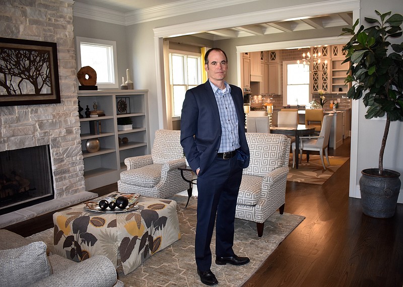 Jim Cheney stands in the living room of one of the model homes at the new Cambridge Square residential development. Cheney said the 130-acre Cambridge Square development is zoned for 320 homes total. The first residents should move in by the end of summer, he said. (STAFF PHOTO BY ALLISON SHIRK)