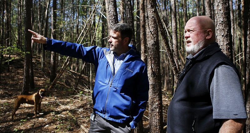 Whitfield County Public Works Director Dewayne Hunt, right, looks on as Whitfield County Geographic Information System Coordinator Jess Hansen gestures at the site of Civil War earthworks on the Grant Farm property on Tuesday, April 17, 2018 in Dalton, Ga.