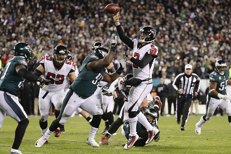 Atlanta Falcons quarterback Matt Ryan throws a touchdown pass under pressure from the Eagles' Fletcher Cox during an NFC divisional-round playoff game last January in Philadelphia. The Eagles won 15-10. The teams will play a rematch Sept. 6 to open the NFL schedule.