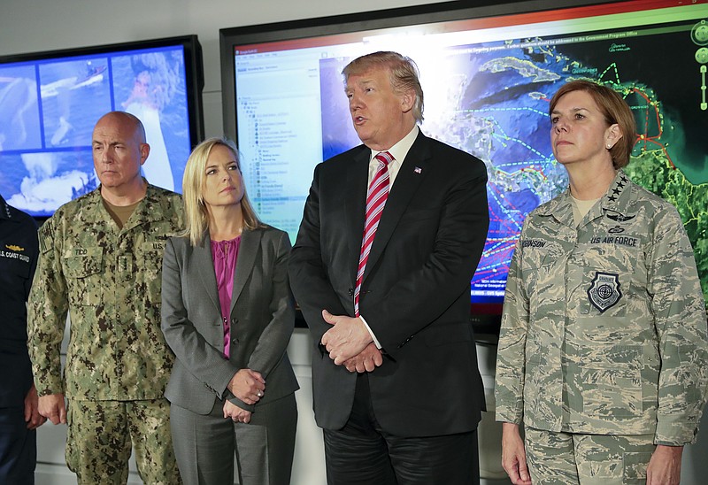 President Donald Trump, center, speaks to members of the media during his visit to Joint Interagency Task Force South anti-smuggling center in Key West, Fla., Thursday, April 19, 2018. Standing with Trump are from left, Navy Adm. Kurt Walter Tidd, commander of the U.S. Southern Command, Kirstjen Nielsen, Secretary of Homeland Security, and Air Force Gen. Lori J. Robinson, commander of the U.S. Northern Command. (AP Photo/Pablo Martinez Monsivais)