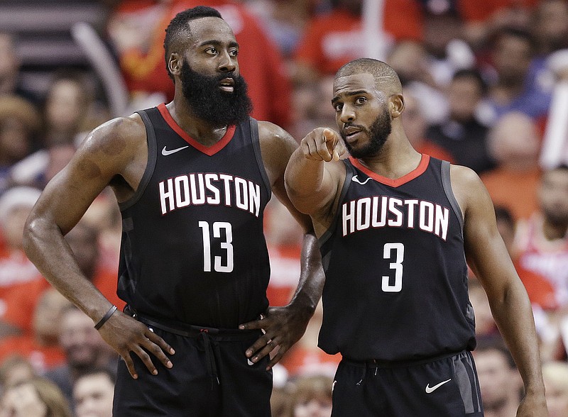 Houston Rockets guard Chris Paul (3) talks to guard James Harden during the second half in Game 2 of a first-round NBA basketball playoff series against the Minnesota Timberwolves, Wednesday, April 18, 2018, in Houston. (AP Photo/Eric Christian Smith)