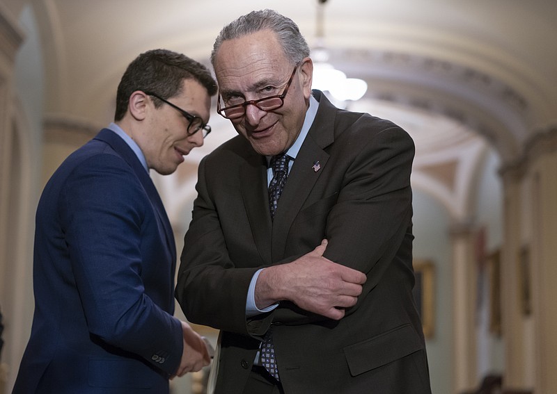 
              Senate Minority Leader Chuck Schumer, D-N.Y., confers with his communications aide Matt House as he speaks to reporters following a closed-door strategy session on Capitol Hill in Washington, Tuesday, April 17, 2018. (AP Photo/J. Scott Applewhite)
            