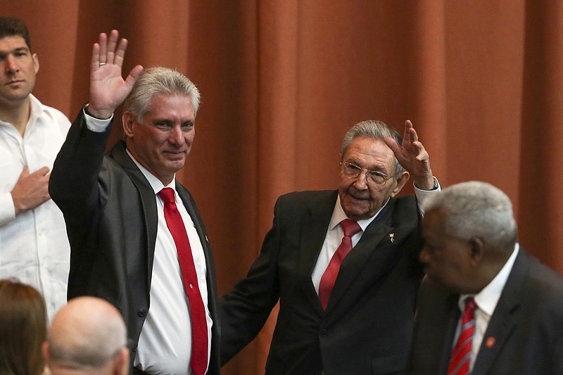 Cuba's new president Miguel Diaz-Canel, left, and former president Raul Castro, salutes, after Diaz-Canel was elected as the island nation's new president, at the National Assembly in Havana, Cuba, Thursday, April 19, 2018. Castro left the presidency after 12 years in office when the National Assembly approved Diaz-Canel's nomination as the candidate for the top government position. (Alexandre Meneghini/Pool via AP)