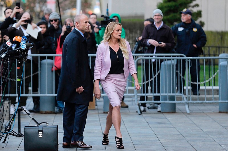 FILE - In this April 16, 2018, file photo, porn actress Stormy Daniels, accompanied by her attorney, Michael Avenatti, left, leaves federal court, in New York. 