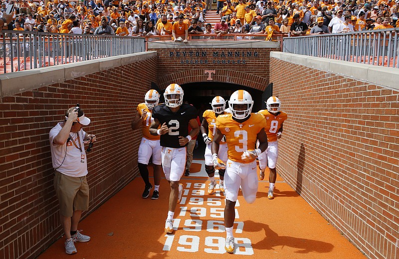 Orange team quarterback Jarrett Guarantano (2) and running back Ty Chandler (3) take the field after halftime of the Orange and White spring game at Neyland Stadium on Saturday, April 21, 2018 in Knoxville, Tenn.