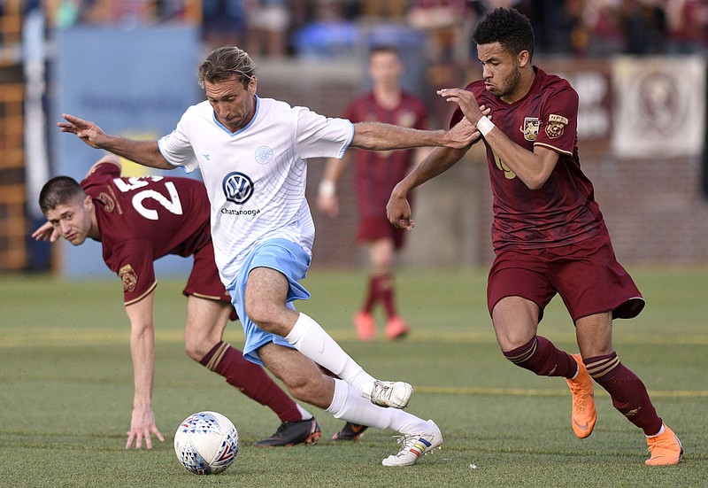 CFC's Juan Hernandez (10) dribbles the ball between two Detroit players.  The Detroit City FC visited the Chattanooga FC at Finley stadium in soccer action on April 21, 2018
