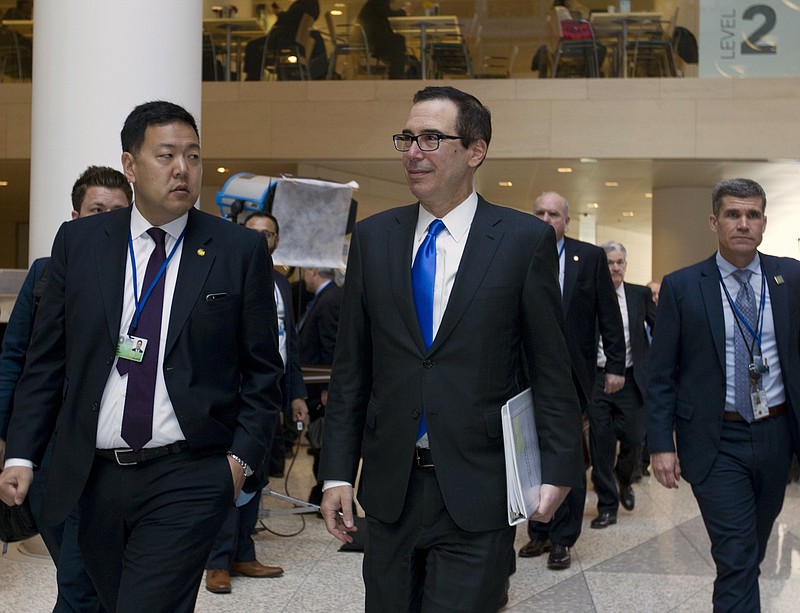 Treasury Secretary Steve Mnuchin, right, accompanied by Deputy Assistant Secretary Jason Chung arrives to the G-20 meeting during the World Bank/IMF Spring Meetings, in Washington, Friday, April 20, 2018. ( AP Photo/Jose Luis Magana)

