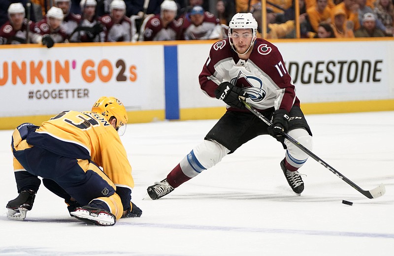 Colorado Avalanche center Tyson Jost (17) makes a move around Nashville Predators left wing Viktor Arvidsson (33), of Sweden, during the first period in Game 5 of an NHL hockey first-round playoff series Friday, April 20, 2018, in Nashville, Tenn. (AP Photo/Sanford Myers)