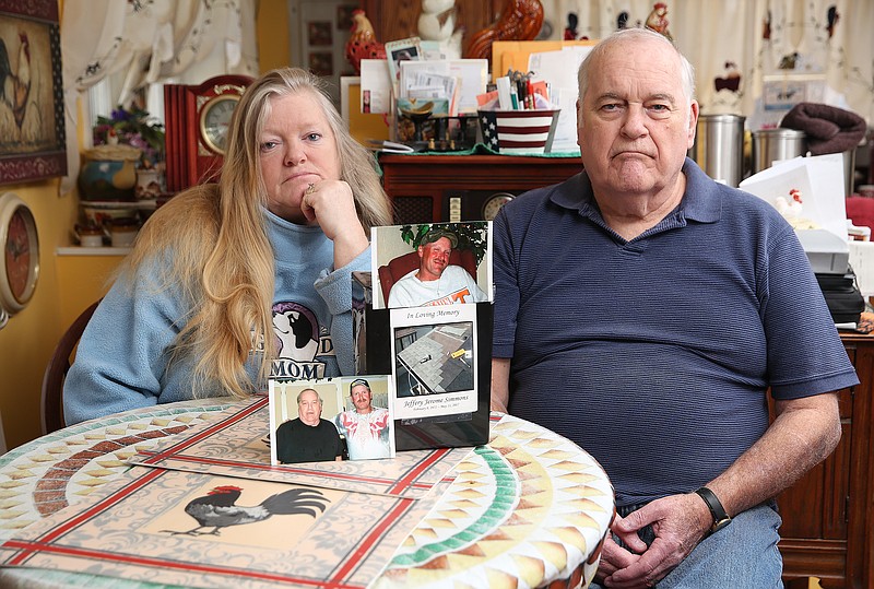 Tina Simmons Honeycutt and her father Malcom Simmons pose for a photo with the remains and photos of Jeffery Simmons, who died in the Hamilton County Jail last year, Thursday, March 15, 2018 in Fort Oglethorpe, Ga. Though the death was ruled accidental, Honeycutt and Simmons believe the death could have been prevented if the Hamilton County Jail had handled the incident differently.