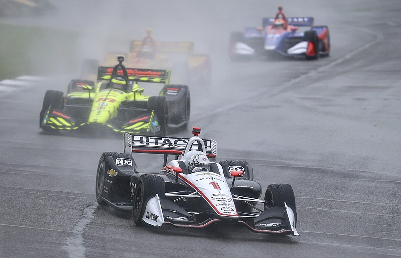 IndyCar driver Josef Newgarden (1) leads a pack of cars during the Honda Indy Grand Prix of Alabama auto race at Barber Motorsports Park, Sunday, April 22, 2018, in Birmingham, Ala. Race is postponed until Monday due to weather. (AP Photo/Butch Dill)