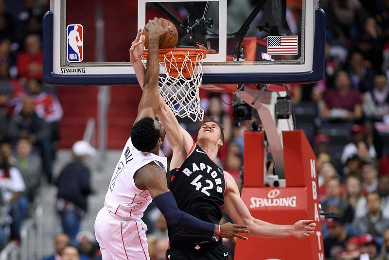 Washington Wizards guard John Wall (2) goes to the basket against Toronto Raptors center Jakob Poeltl (42) during the first half of Game 4 of an NBA basketball first-round playoff series, Sunday, April 22, 2018, in Washington. (AP Photo/Nick Wass)