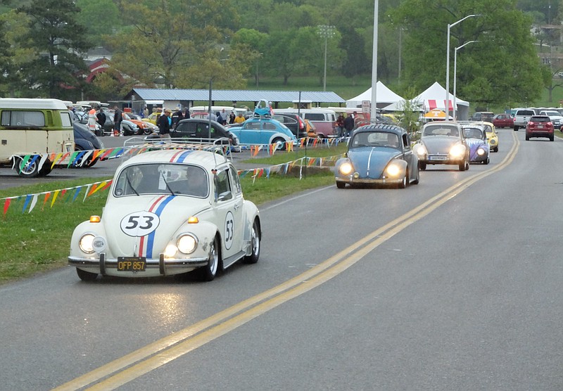 Will Nelms, of Murfreesboro, leads a line of vintage Volkswagen beetles out of Camp Jordan Sunday morning as rain shortens the 20th annual Bug-a-Paluza in East Ridge.