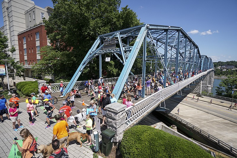 Spectators watch as competitors cross the Walnut Street Bridge during the 2016 Sunbelt Bakery Ironman 70.3 event in downtown Chattanooga on May 22.