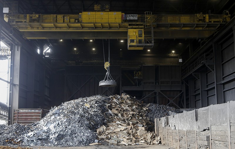 A giant magnet hovers over scrap metal at the Waupaca Foundry.