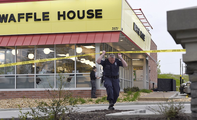 Law enforcement officials work the scene of a fatal shooting at a Waffle House in the Antioch neighborhood of Nashville, Sunday. (George Walker IV/The Tennessean via AP)