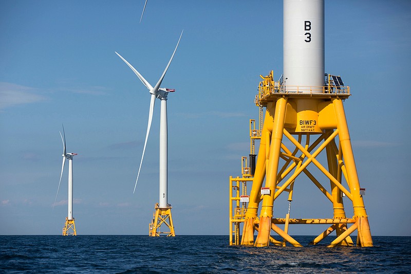 FILE - In this Aug. 15, 2016, file photo, three of Deepwater Wind's turbines stand in the water off Block Island, R.I. Using federal offshore leases, wind power projects along the East Coast are pressing ahead in 2018, with the goal of transforming the electric grid and providing energy to power millions of homes. (AP Photo/Michael Dwyer, File)