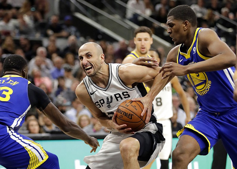 Golden State Warriors' Draymond Green (23) and Kevon Looney (5) defend against a drive to the basket by San Antonio Spurs' Manu Ginobili, center, during the first half of Game 3 of a first-round NBA basketball playoff series in San Antonio, Thursday, April 19, 2018. (AP Photo/Eric Gay)
