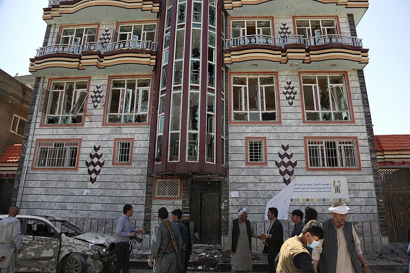 People gather outside a voter registration center which was attacked by a suicide bomber in Kabul, Afghanistan, Sunday, April 22, 2018. Gen. Daud Amin, the Kabul police chief, said the suicide bomber targeted civilians who had gathered to receive national identification cards. (AP Photo/ Rahmat Gul)
