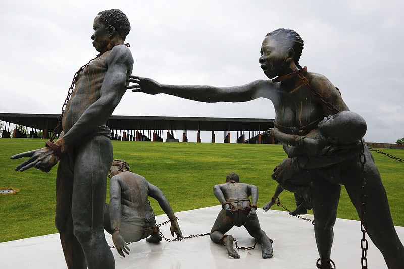 Part of a statue depicting chained people is on display at the National Memorial for Peace and Justice, a new memorial to honor thousands of people killed in racist lynchings, Sunday, April 22, 2018, in Montgomery, Ala. The national memorial aims to teach about America's past in hope of promoting understanding and healing. It's scheduled to open on Thursday. (AP Photo/Brynn Anderson)

