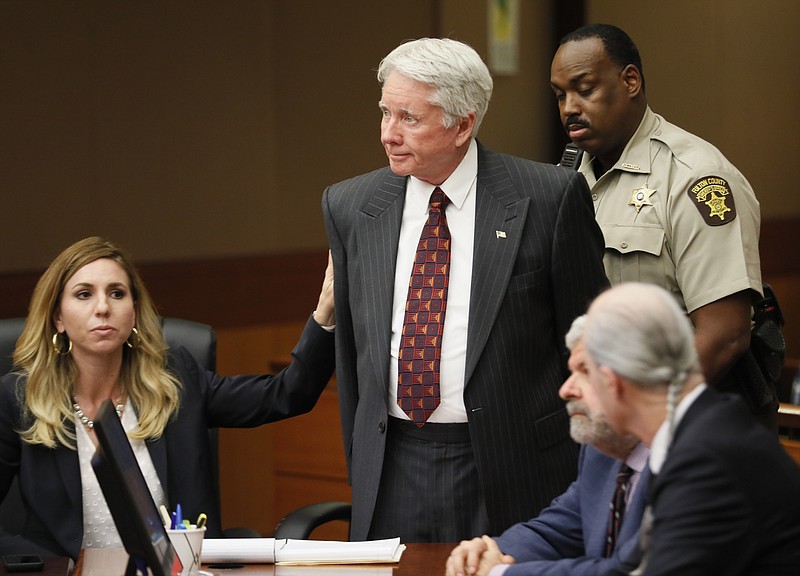 Standing amidst his attorneys, including Amanda Clark Palmer, left, Tex McIver is handcuffed and taken into custody after a jury found him guilty of murder and influencing witnesses on their fifth day of deliberations Monday, April 23, 2018 at the Fulton County Courthouse in Atlanta. (Bob Andres/Atlanta Journal-Constitution via AP, Pool)

