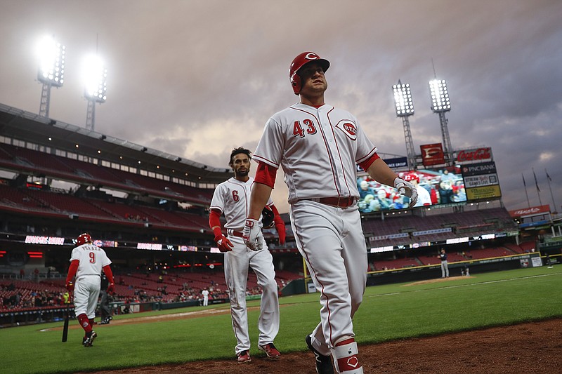 Cincinnati Reds' Scott Schebler (43) walks back to the dugout after hitting a two-run home run off Atlanta Braves starting pitcher Mike Foltynewicz in the fifth inning of a baseball game, Monday, April 23, 2018, in Cincinnati. (AP Photo/John Minchillo)